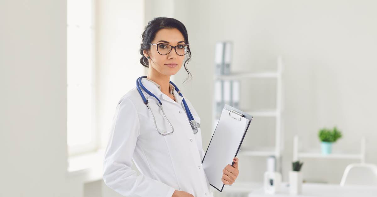 Young female doctor with a stethoscope around her neck and a clipboard in her hand