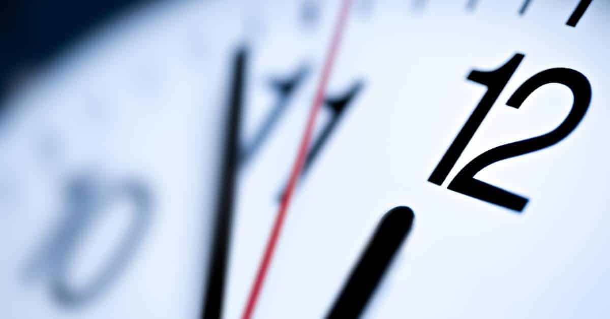 Clock with the hour hand on 12 and the minute hand on 54 minutes