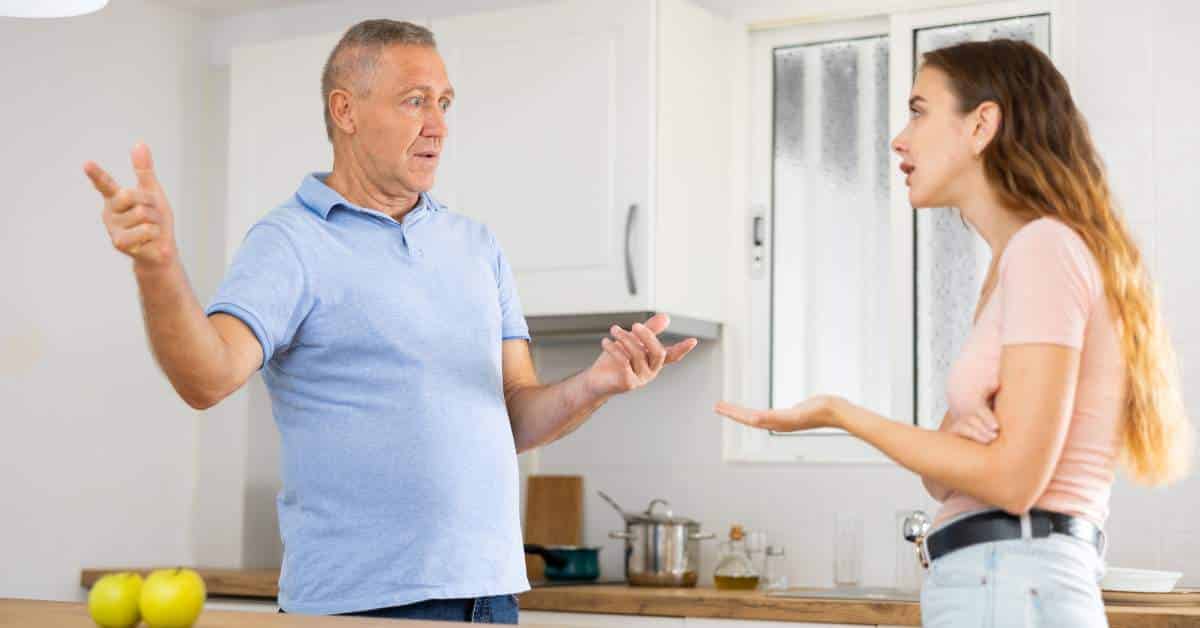 Teen daughter arguing with her white-haired, middle-aged father