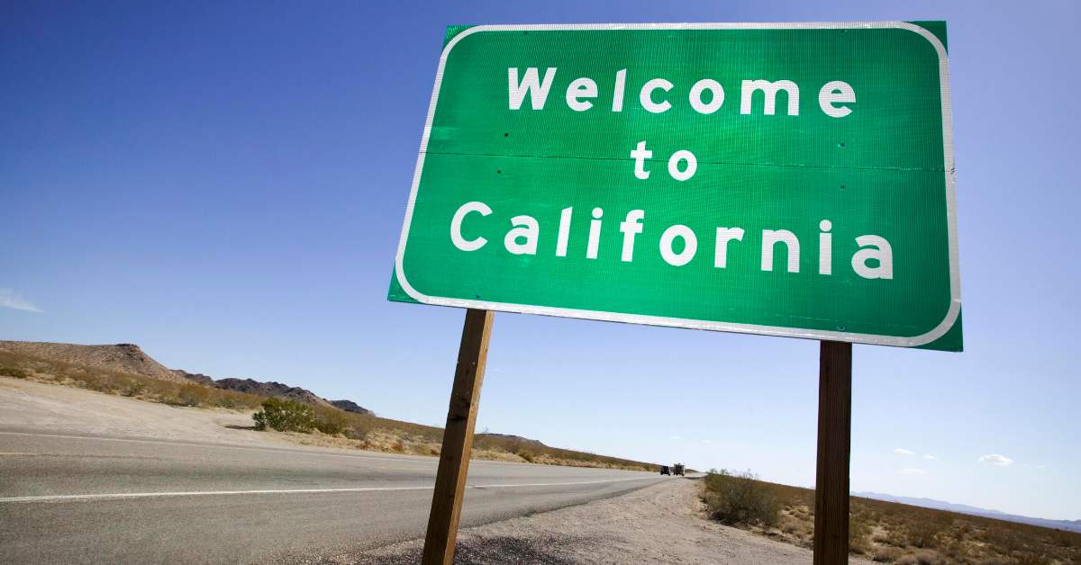 Green road sign reads, "Welcome to California"